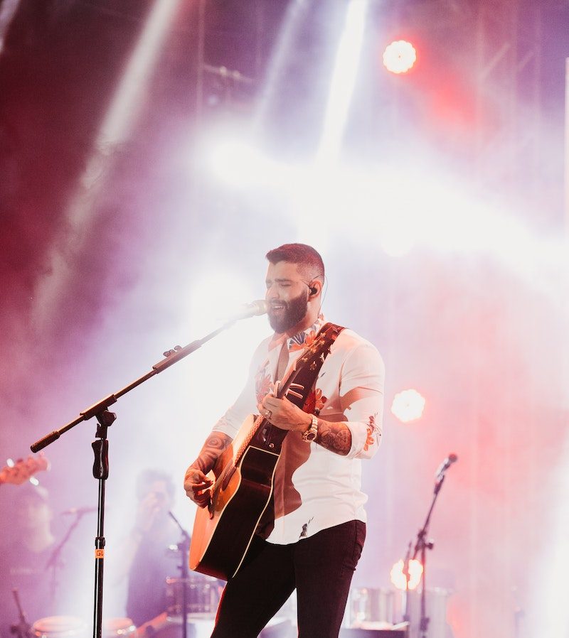 Man Playing Guitar on Stage